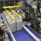 Automatic case packer for side loading of oil containers