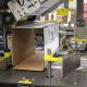 Automatic case packer for side loading of oil containers
